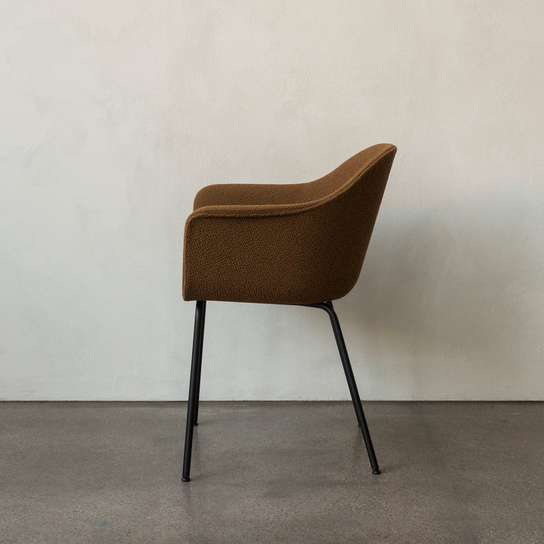 Brown textured chair with black legs against a neutral background. Perfect for modern home decor.