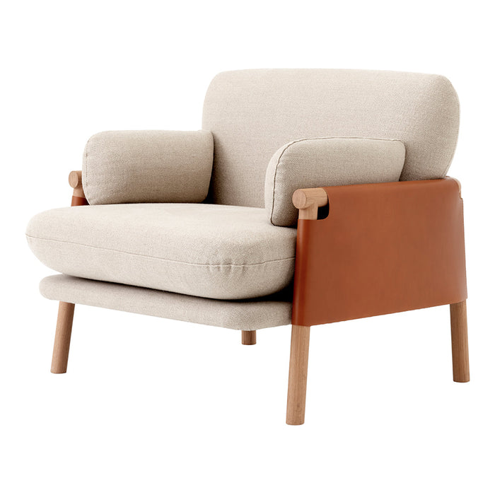 Beige fabric armchair with a brown leather side pocket and natural wood legs, featuring a minimalist design.