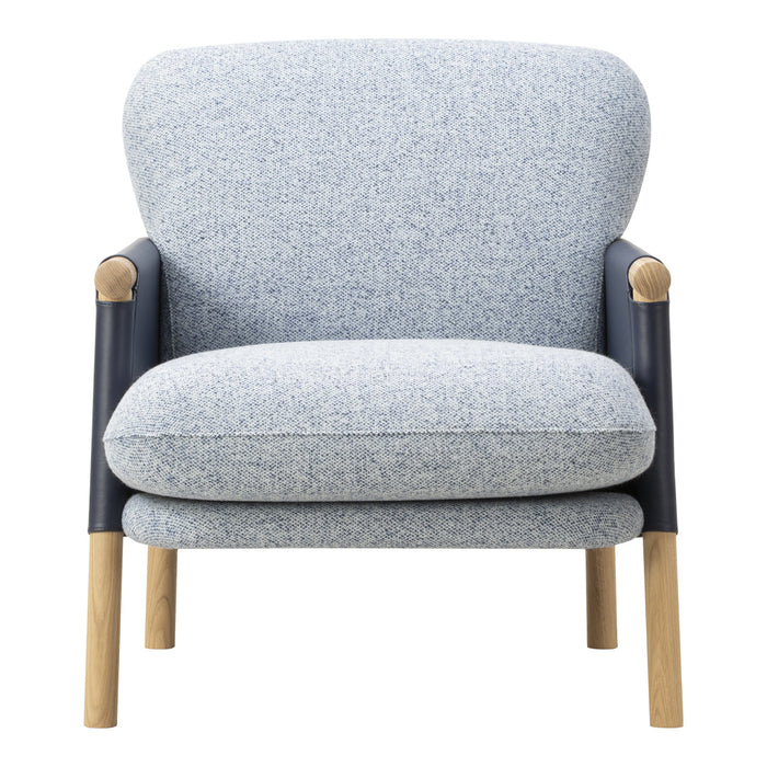 Light blue speckled fabric armchair with dark blue armrests and natural wood legs. Modern, cozy design for any space.