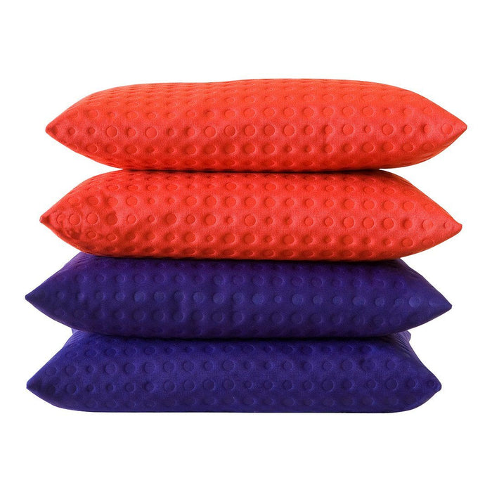 Stacked pillows in vibrant orange and deep purple, featuring a textured dot pattern for a modern look.