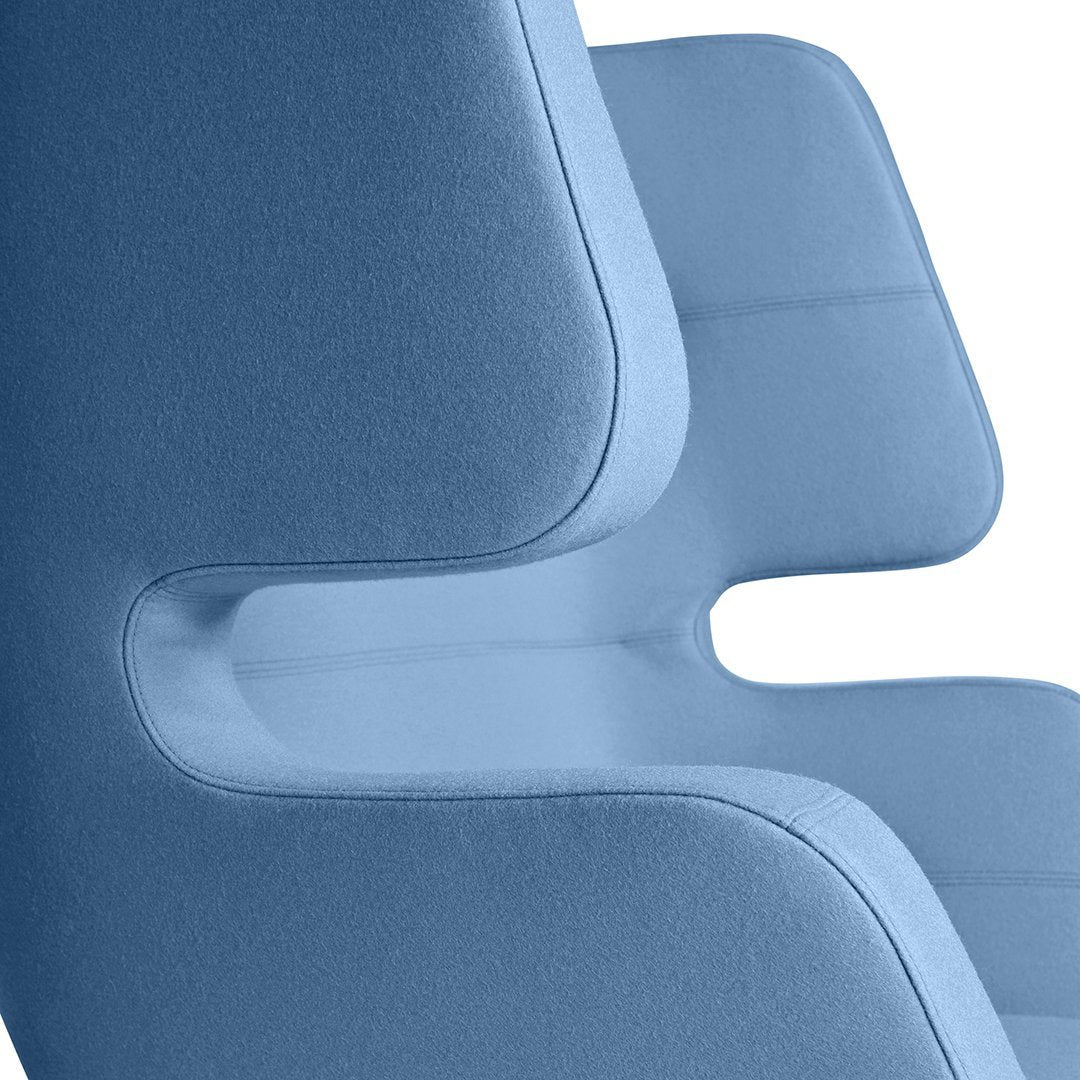 Stylish chair in soft blue fabric with smooth, modern contours and minimalistic design. Perfect for contemporary decor.