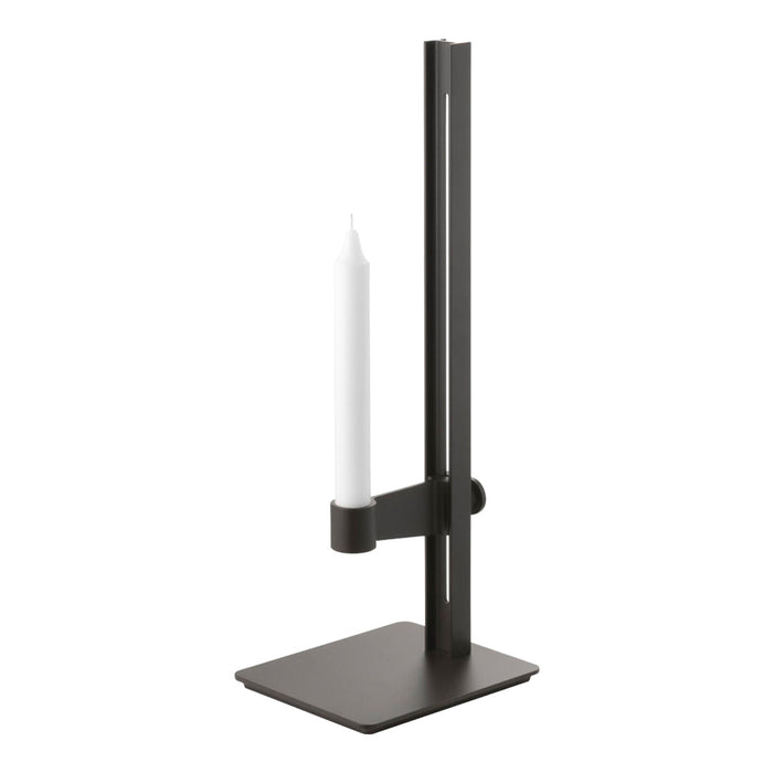 Black metal candle holder with a sleek, modern design and a simple white candle.