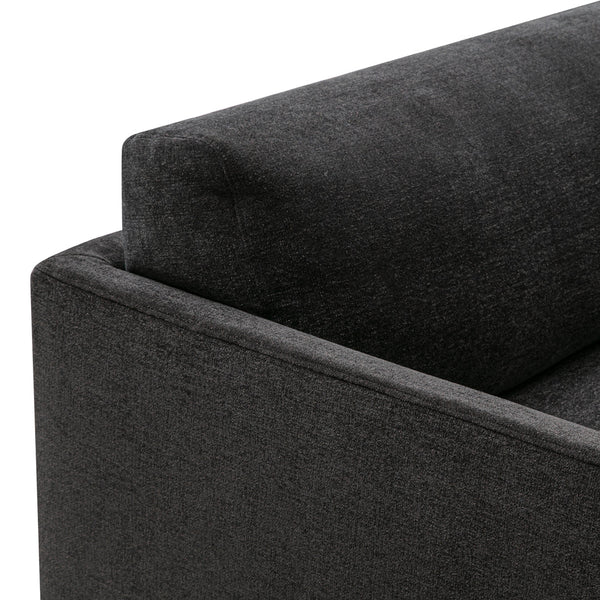 Dark gray fabric sofa corner with clean lines and a subtle texture, perfect for modern interior designs.