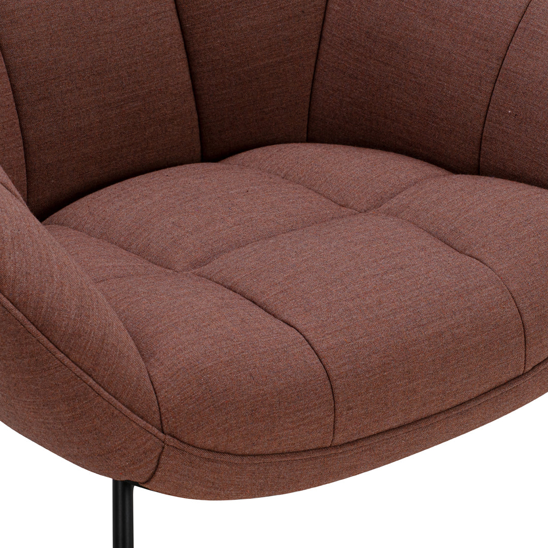 Brown upholstered armchair with tufted design and sleek black metal legs. Ideal for modern interiors.