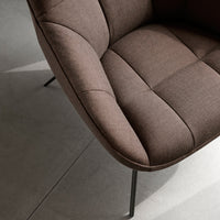 "Curved brown upholstered chair with textured fabric and grid pattern, set against a light gray background."