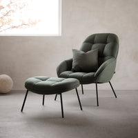 Green fabric accent chair with tufted pattern and matching ottoman, set against a minimalist concrete backdrop.