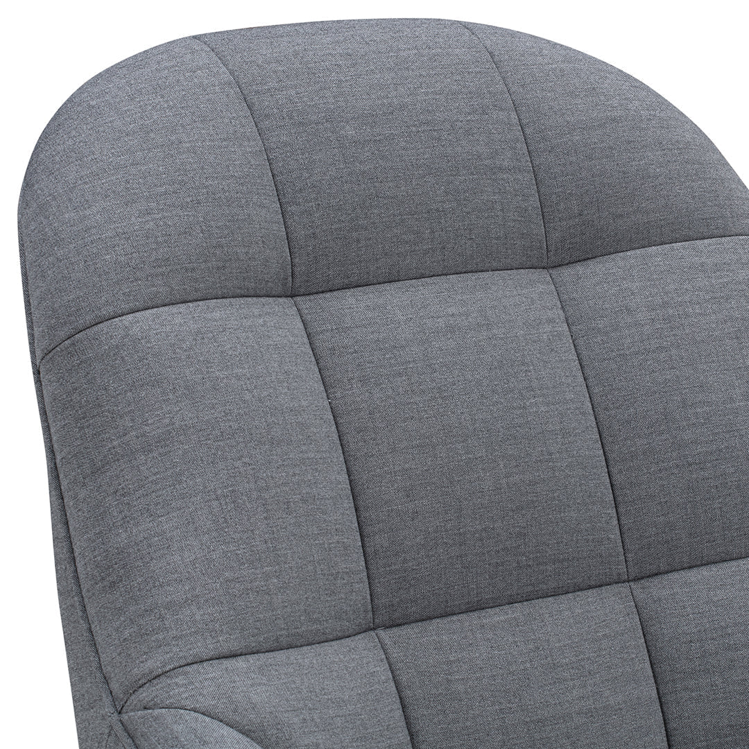 Gray upholstered chair with a modern quilted pattern and smooth, rounded edges. Ideal for contemporary interiors.