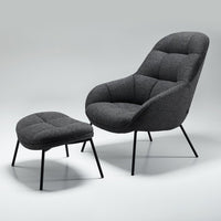 Gray upholstered armchair and ottoman set with tufted patterns and black metal legs. Perfect for modern decor.