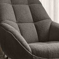 Gray textured chair with tufted upholstery, showcasing a modern, cozy pattern perfect for contemporary decor.
