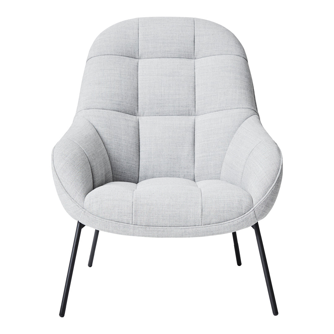Light gray upholstered chair with a quilted pattern and sleek black metal legs. Perfect for modern interiors.
