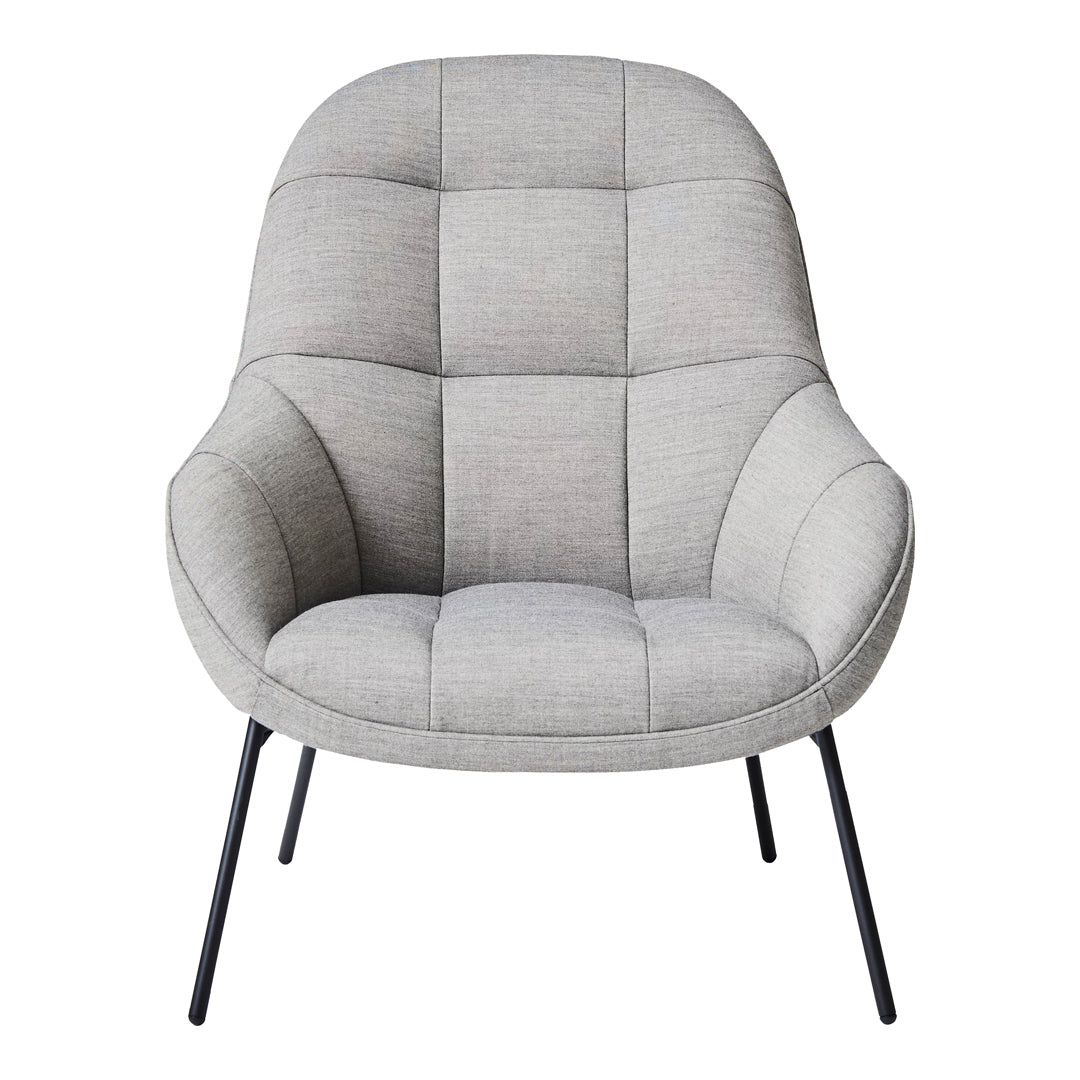 Light grey chair with a quilted pattern and curved design, featuring black metal legs for a modern look.