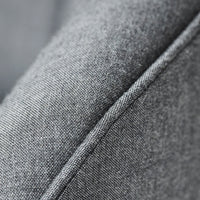 Close-up of textured gray fabric with subtle diagonal weave pattern and contrasting stitch detail.
