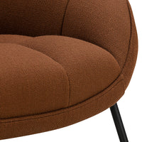 Brown textured fabric with a quilted pattern and sleek black legs. Perfect accent chair for modern decor.