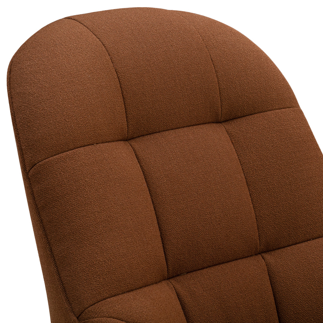 Brown upholstered chair with tufted fabric, featuring smooth curves and a warm, inviting texture.