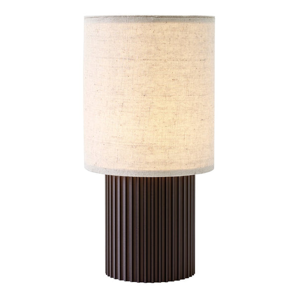 Beige fabric lampshade atop a ribbed brown base, creating a modern and minimalist design.