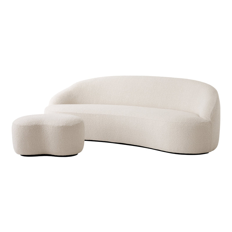 Curved cream sofa with matching rounded ottoman, featuring a soft, textured fabric. Modern style for contemporary decor.