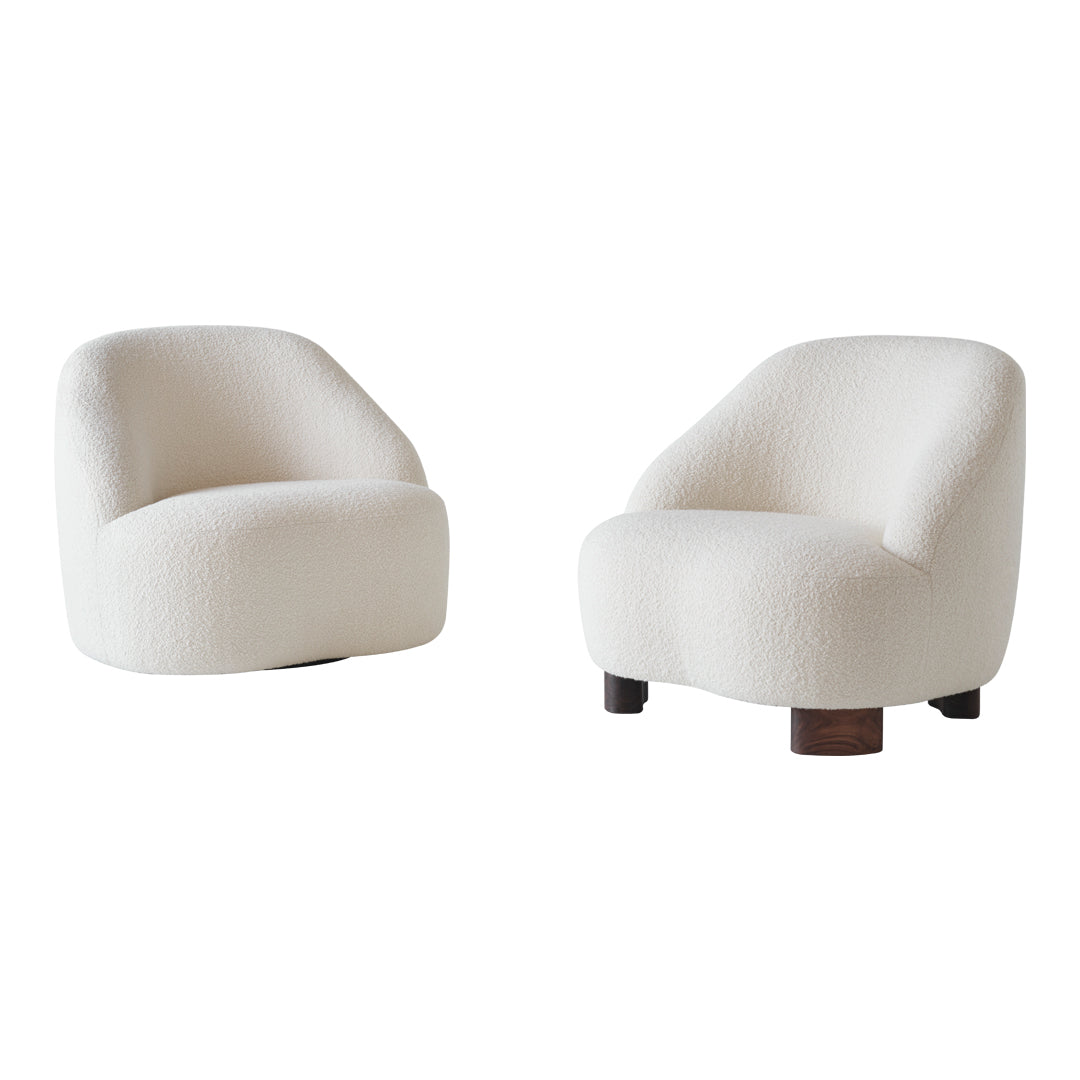 Soft white upholstered armchairs with rounded shapes and textured patterns, featuring contrasting wooden bases.