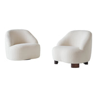 Soft white upholstered armchairs with rounded shapes and textured patterns, featuring contrasting wooden bases.