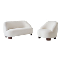 Stylish white boucle sofa and armchair set with rounded shapes and dark wooden legs. Perfect for modern decor.