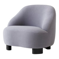 Soft grey velvet chair with smooth curves and black wooden legs, ideal for modern decor.