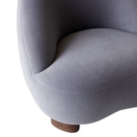 Soft gray fabric with subtle texture, featuring a smooth, rounded shape and a natural wood base.