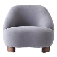 Soft gray upholstered chair with rounded design and wooden legs, perfect for modern decor.