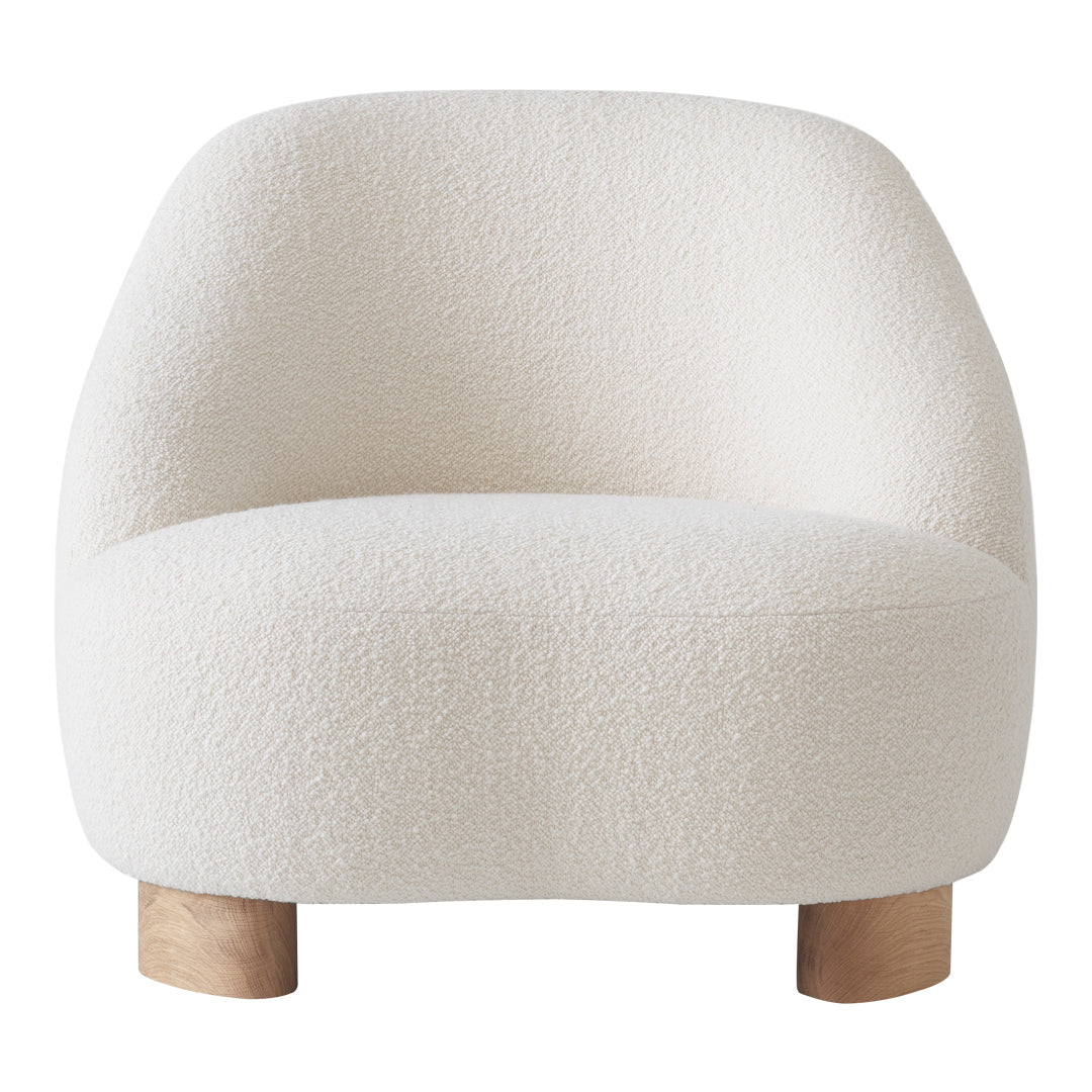 Soft cream lounge chair with a textured, boucle fabric and natural wooden legs. Perfect for modern interiors.