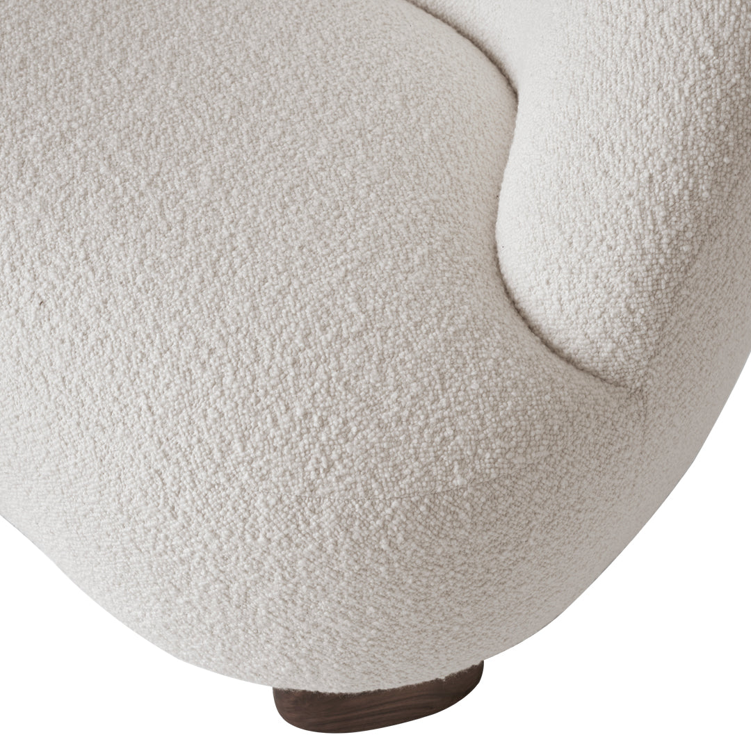 Textured off-white upholstery with a cozy, boucle pattern and a smooth wood base. Perfect for modern decor.