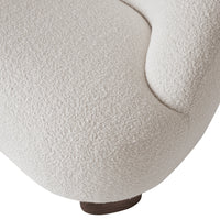 Textured off-white upholstery with a cozy, boucle pattern and a smooth wood base. Perfect for modern decor.