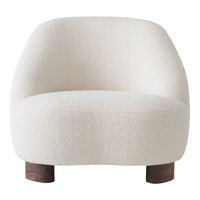 White boucle accent chair with soft, textured fabric and rounded silhouette, featuring wooden legs.