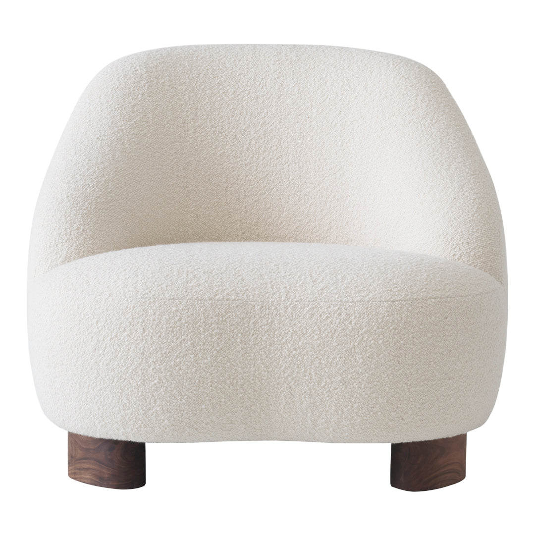 White boucle accent chair with soft, textured fabric and rounded silhouette, featuring wooden legs.