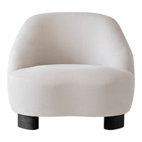 Soft beige rounded chair with a smooth texture and black wooden legs, perfect for modern decor.