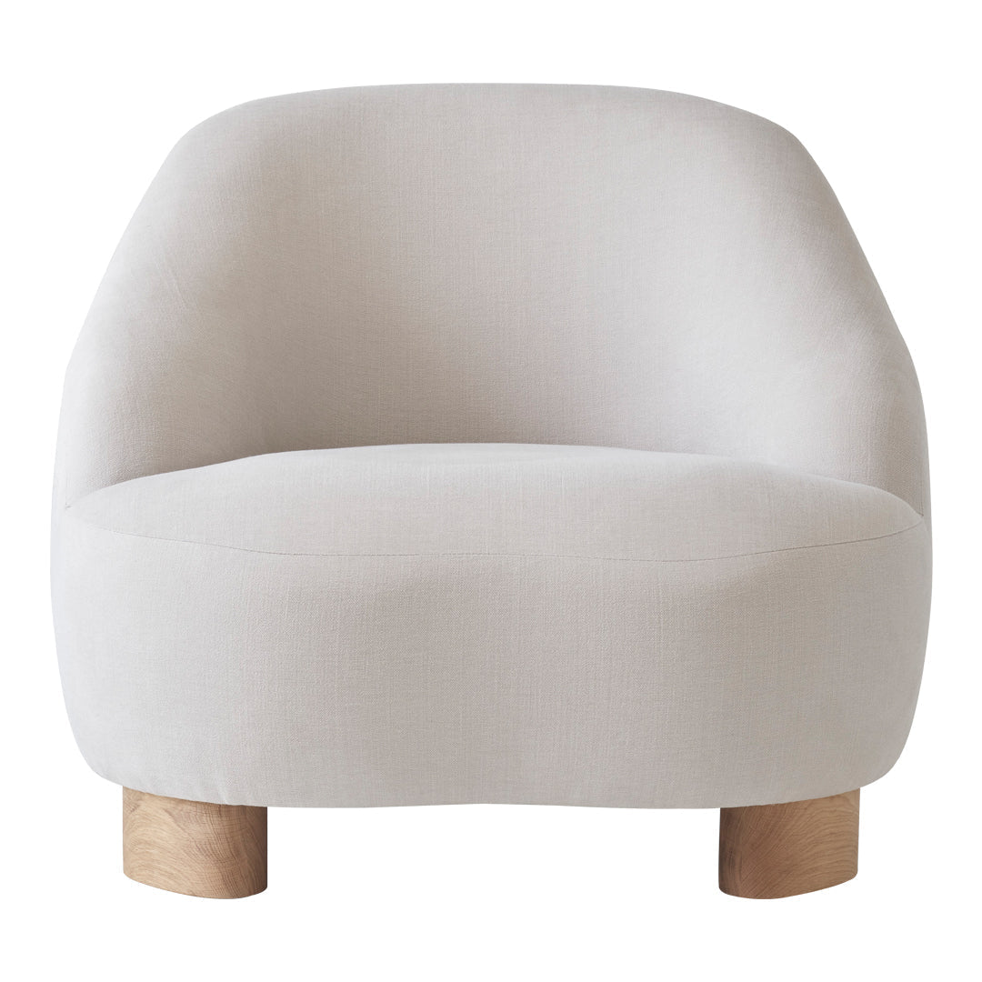 Soft, light beige upholstered chair with smooth curves and natural wood legs, perfect for modern interiors.