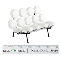 White circular cushions on a sleek black metal frame create a modern, minimalist design. Perfect for contemporary decor.