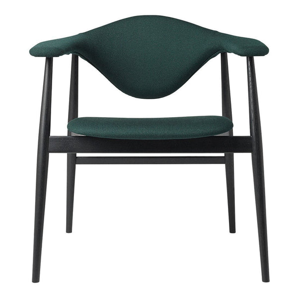 "Green upholstered chair with a sleek black frame, featuring a smooth, curved backrest."