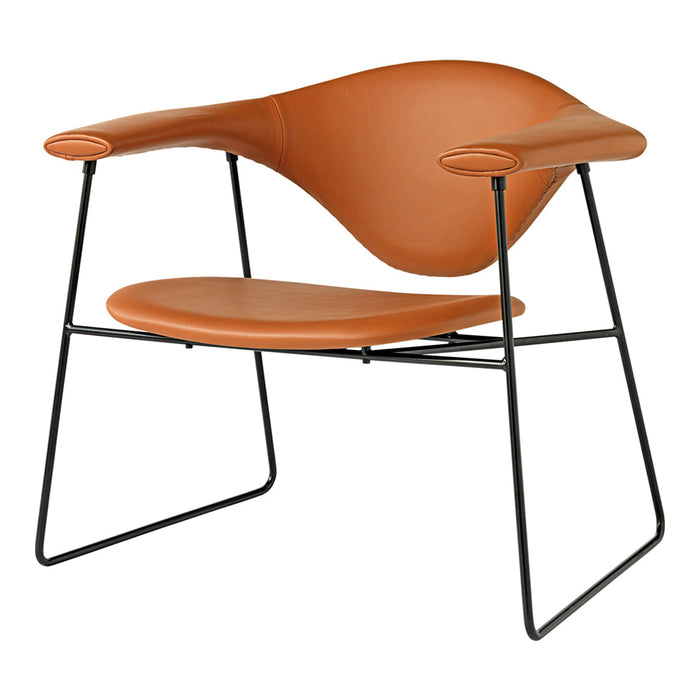 Tan leather armchair with smooth curves and a sleek black metal frame.