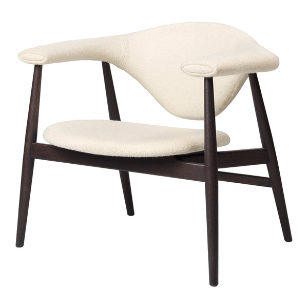 Cream upholstered chair with a smooth, curved design and dark wooden legs for a modern, minimalist look.