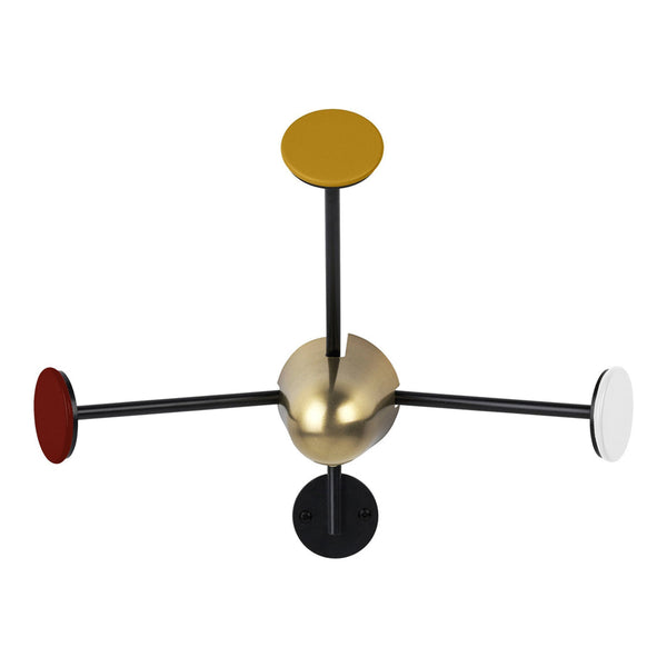 Modern lamp with a sleek gold center and colorful round accents in yellow, red, white, and black on slender rods.