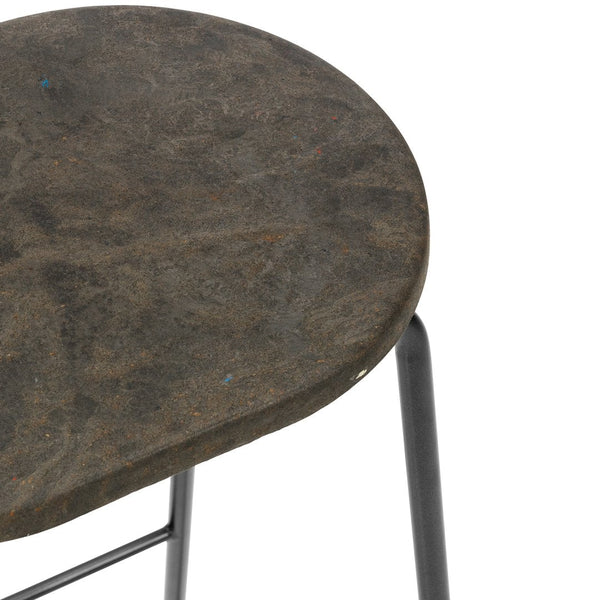 Dark gray, textured round stool seat with black metal legs, featuring subtle variations in color and pattern.