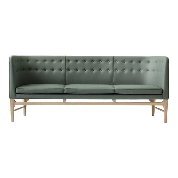 Stylish green upholstered sofa with tufted backrest and wooden legs, perfect for modern living spaces.