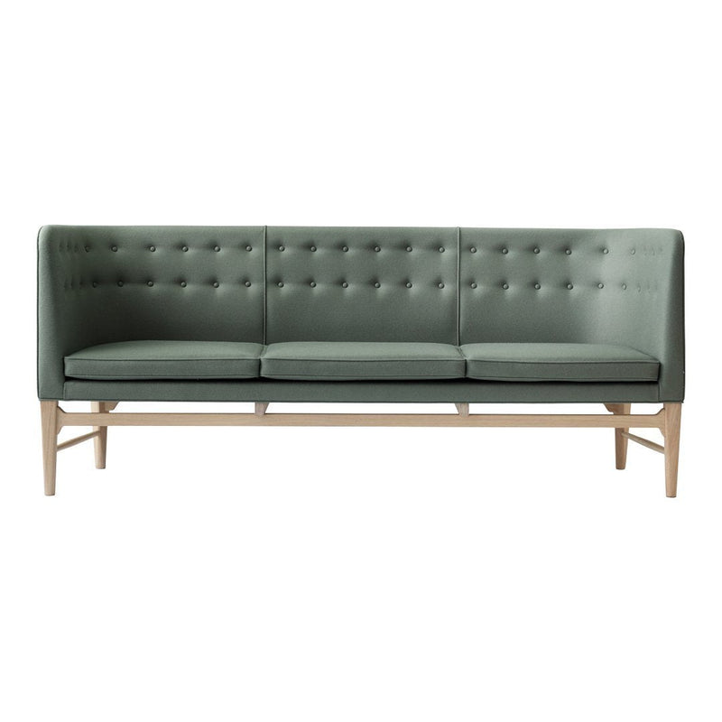 Stylish green upholstered sofa with tufted backrest and wooden legs, perfect for modern living spaces.