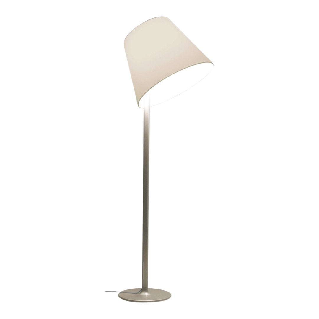 Modern white floor lamp with a sleek silver base and minimalist design, featuring a soft, neutral color palette.