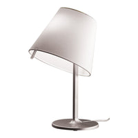Modern silver table lamp with a white fabric shade, featuring a sleek, minimalist design.