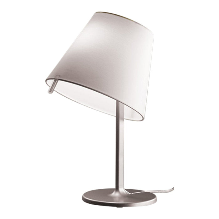 Modern silver table lamp with a white fabric shade, featuring a sleek, minimalist design.