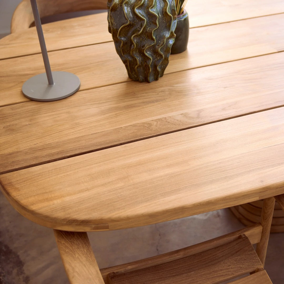 Light oak wooden table with smooth surface, featuring natural grain patterns and a simple, elegant design.