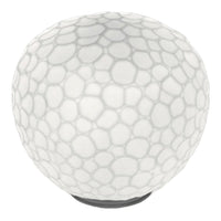 White round lamp with a textured bubble pattern and a sleek black base, ideal for modern decor.