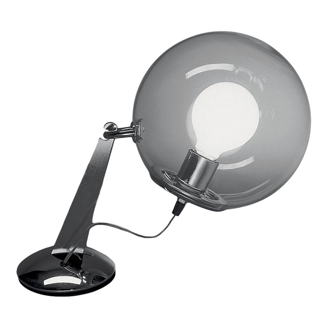 Sleek chrome desk lamp with a clear round glass shade and black base, creating a modern, minimalist aesthetic.