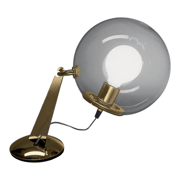 Stylish brass lamp with a round, clear glass shade, featuring a sleek modern design.