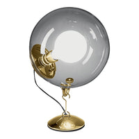 "Gold base and detailing with a large, clear spherical glass shade."