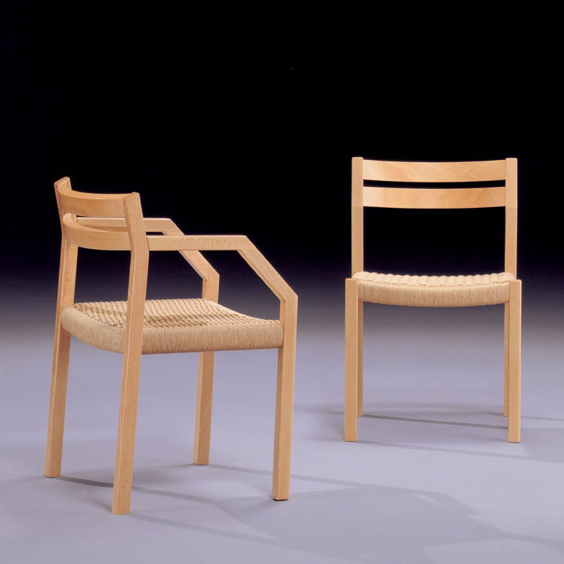 Natural wood finish, minimalist design, featuring woven seat pattern and simple lines. Elegant chair set for modern decor.